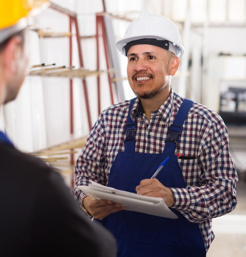 mechanical-engineer-inspecting-work-labour-factory-smiling-american-modern-78216025